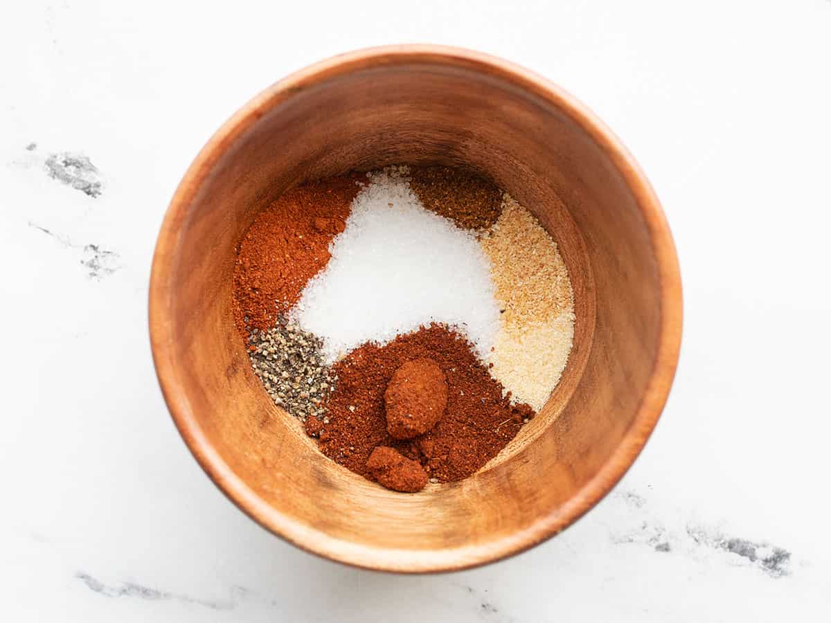 Spices for the chili rubbed pulled pork in a small wooden bowl