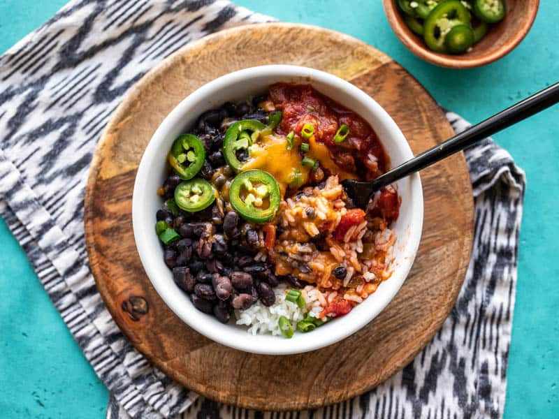 Overhead view of a Poor Man's Burrito Bowl with a black fork stuck in the middle