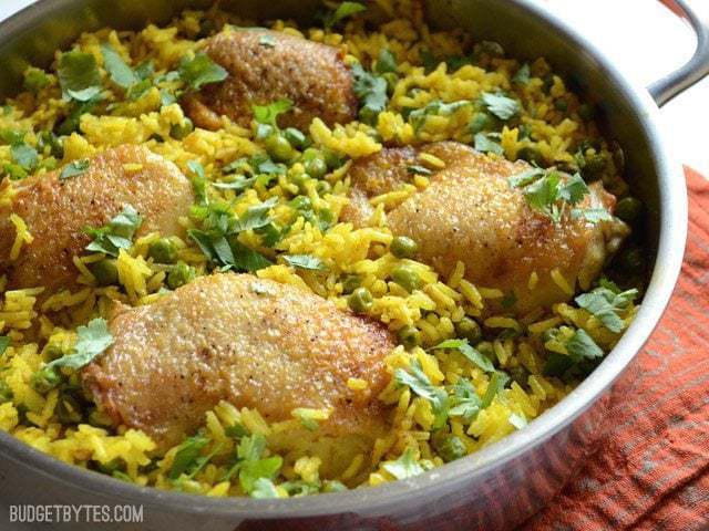 A close-up of yellow rice chicken skillet in a pan.