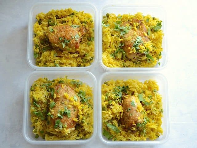 Yellow Rice Chicken Skillet divided into plastic meal prep containers