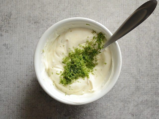 Fresh Dill added to bowl of dip