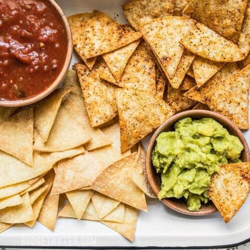 These Homemade Baked Tortilla Chips are fast, easy, super crunchy, a great way to use up leftover tortillas, and a great alternative to store bought chips. Budgetbytes.com