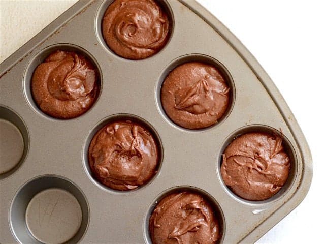 Brownie Batter in a Muffin Tin and Ready to Bake