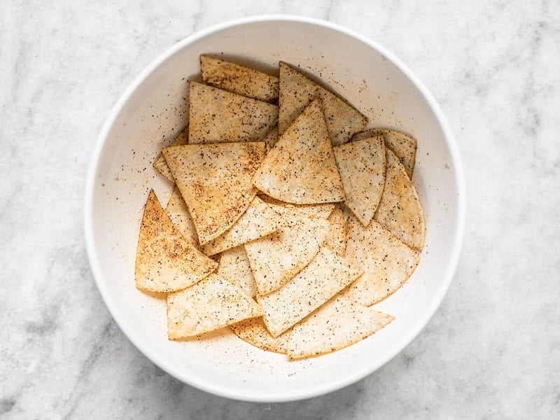 Coat oiled tortilla wedges in spices