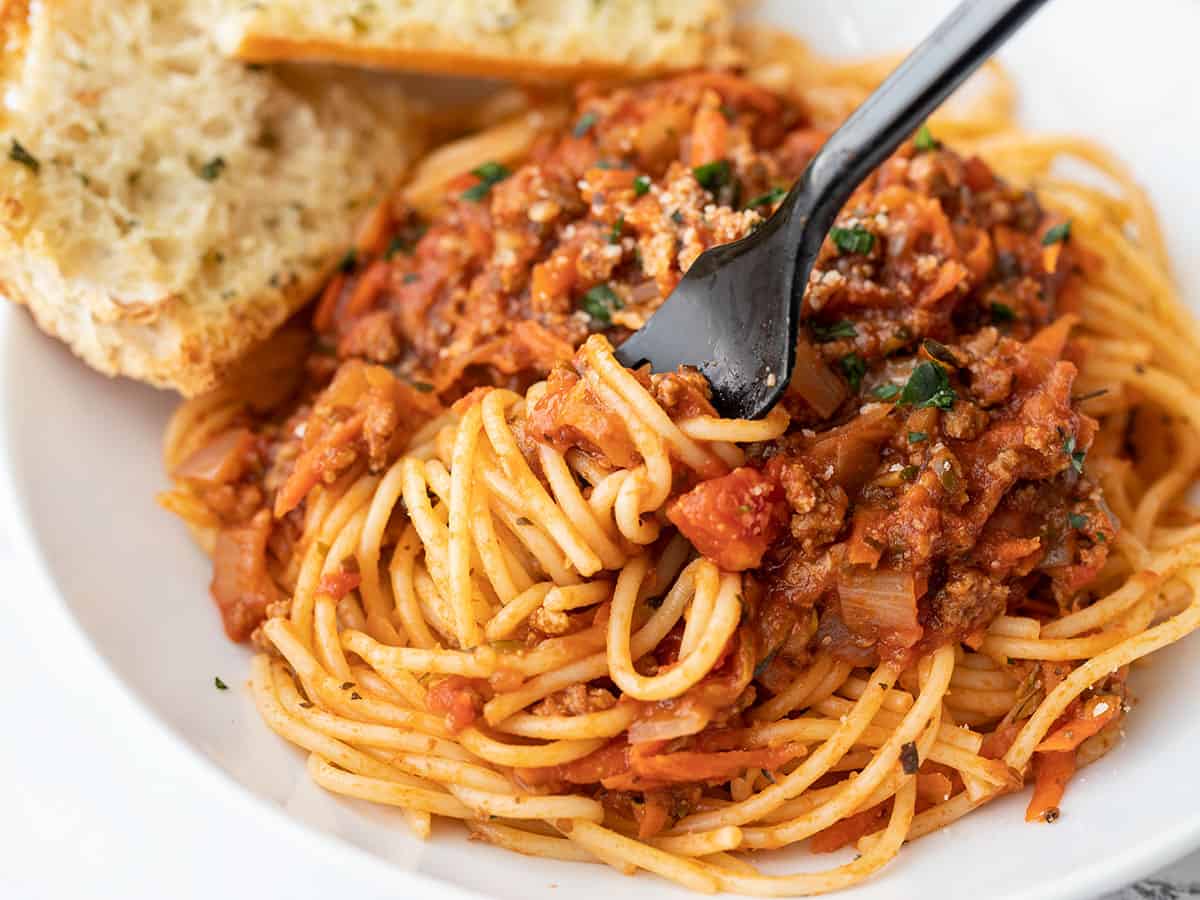 Close up of a fork twirling spaghetti with hidden vegetable pasta sauce