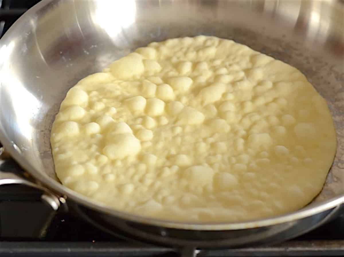 dough in the hot skillet with tons of bubbles rising. 