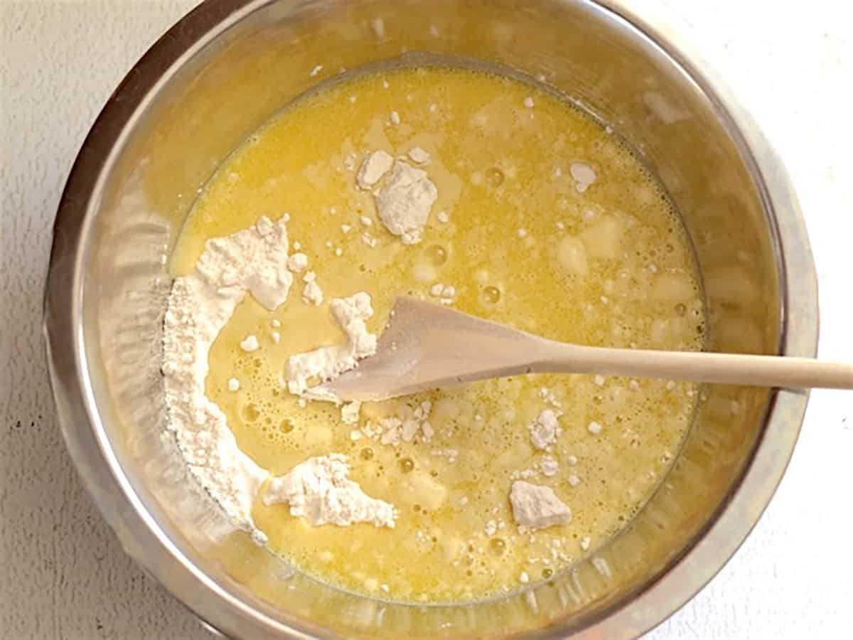 Wet ingredients poured into the metal bowl with the dry ingredients. 