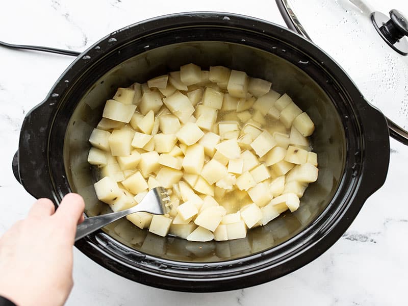 testing the potatoes tenderness with a fork