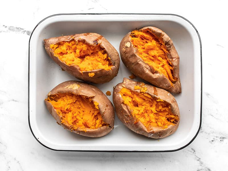 Opened and mashed sweet potatoes in the baking dish