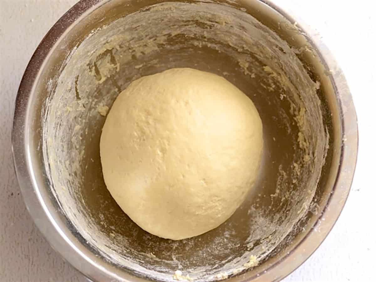 Naan dough back in the metal bowl ready to rise.