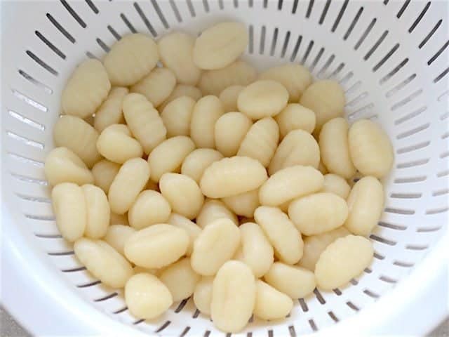 Gnocchi draining in a colander