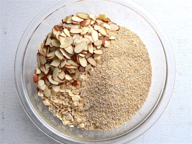 Oats, oat bran, and almonds in a glass bowl