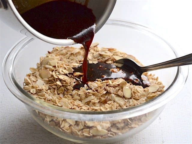 Wet ingredients being poured into the bowl of dry ingredients