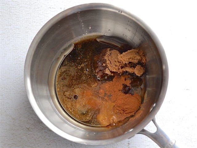 Molasses, brown sugar, oil, and spices in a sauce pot