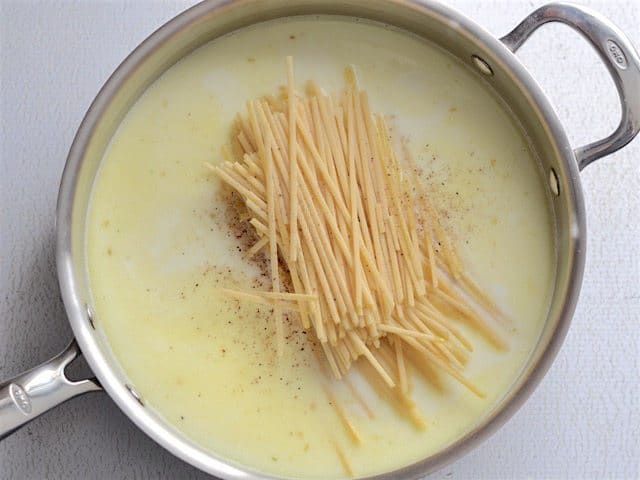 Broth, Milk, Pasta, Salt, and Pepper added to the skillet