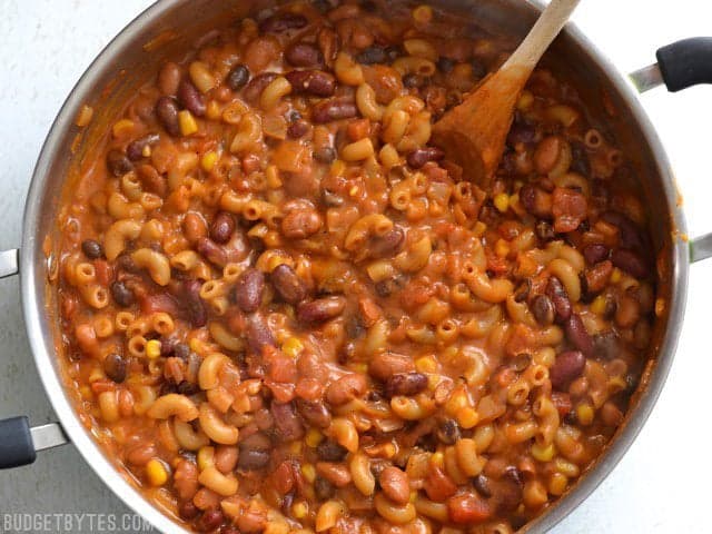 Overhead view of one pot vegetarian chili mac and cheese in the pot with a wooden spoon