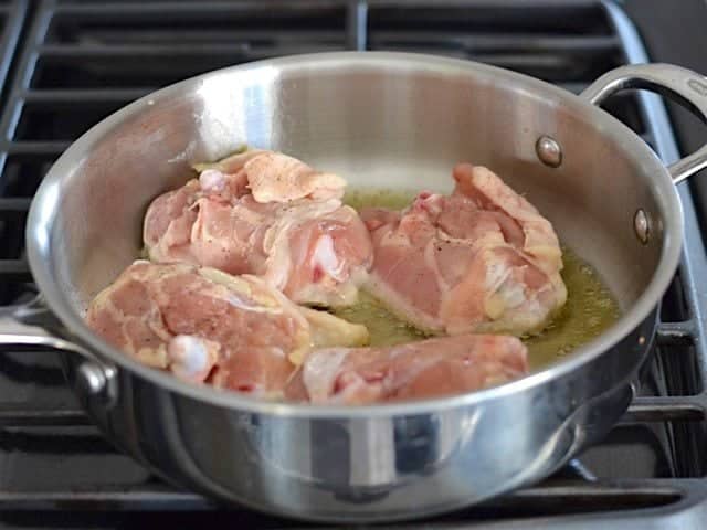 Chicken Thighs cooking in the Skillet, skin side down