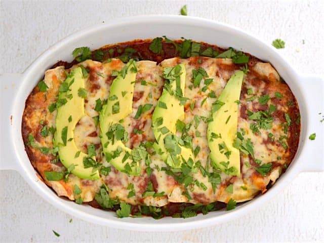 Finished Weeknight Enchiladas, topped with avocado and cilantro