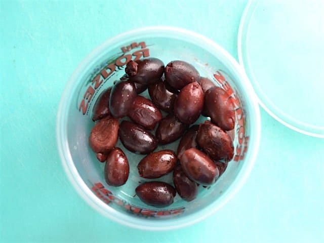 Kalamata Olives in a small salad bar container