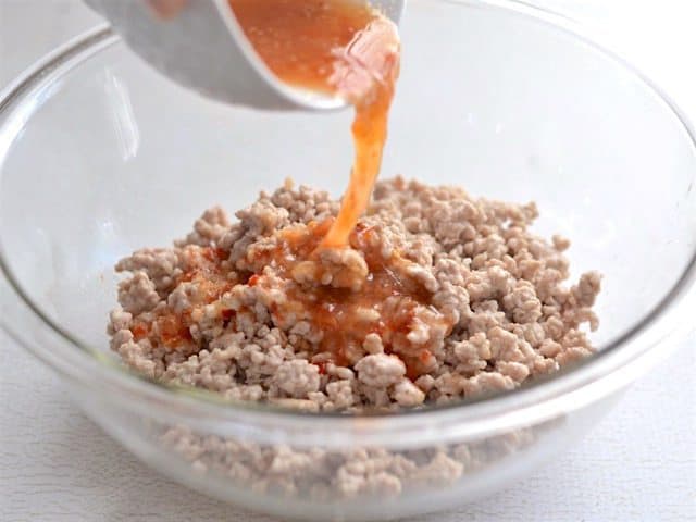 Dressing poured over the ground pork