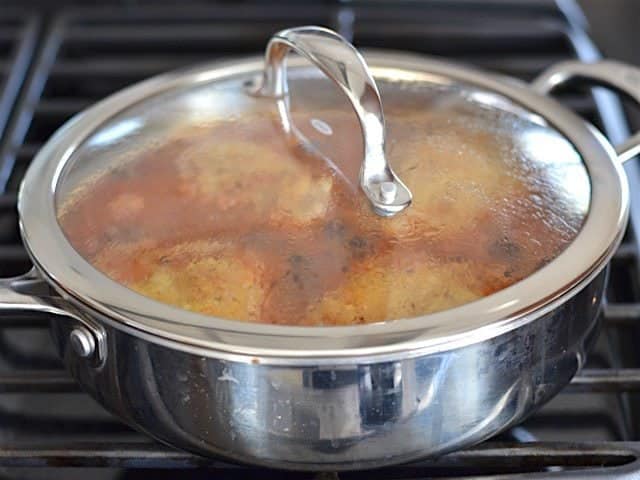 Lid on skillet, chicken and orzo simmering.