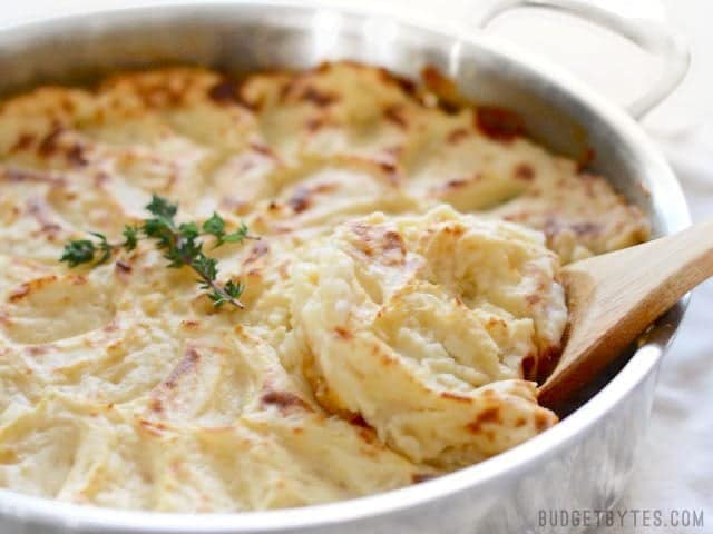 Side shot of fluffy mashed potatoes on top of Vegetarian Shepherd's Pie.