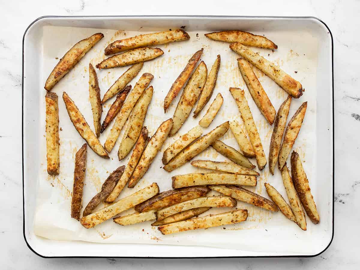 baked garlic parmesan fries on the baking sheet