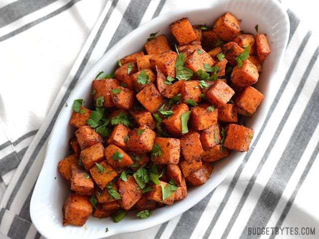 Chili roasted sweet potatoes arranged on a plate.