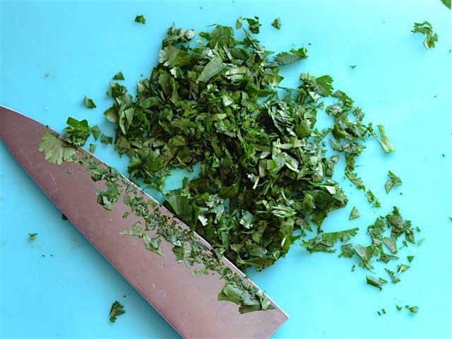 Chopped Cilantro on a blue cutting board