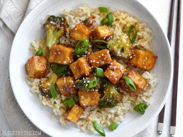 Pan-fried sesame tofu with broccoli in a bowl.