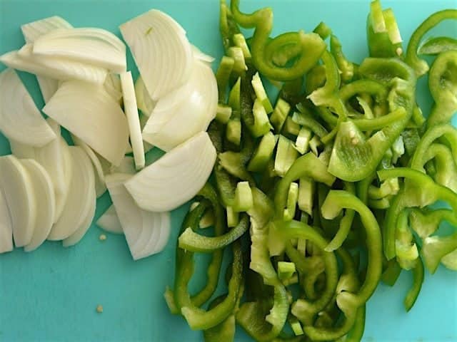 Sliced Onion and Peppers on a cutting board