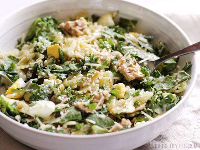 Kale and salmon Caesar salad served in a bowl.