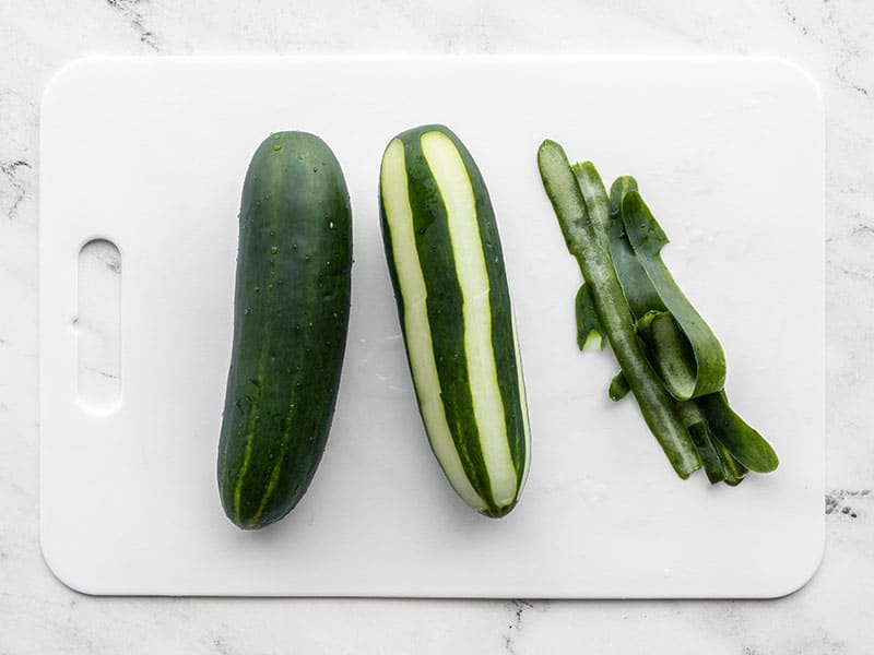 Two cucumbers, one half peeled