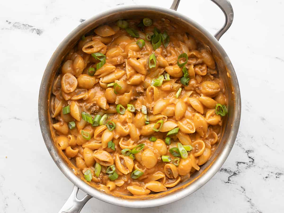 cheeseburger pasta skillet topped with sliced green onions