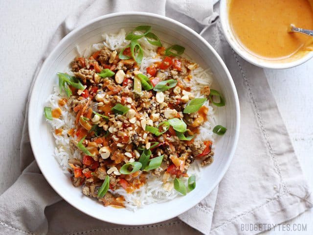 Chopped peanuts added to the bowl of hoisin stir fry. Small bowl of spicy peanut sauce on the side.