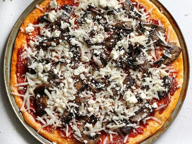 Mozzarella, mushrooms, and feta added to pizza