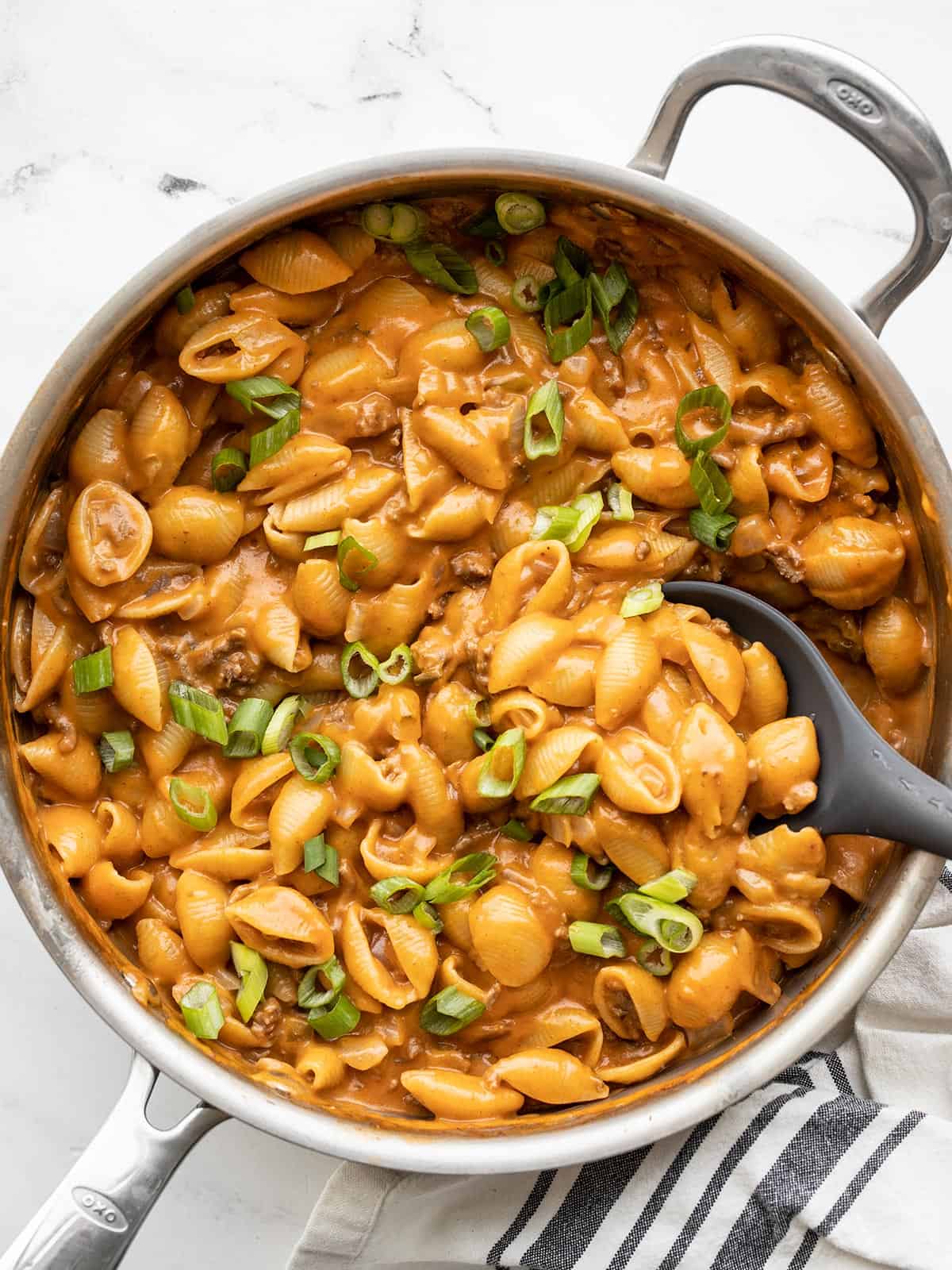 Overhead view of cheeseburger pasta skillet in the pan with a spatula in the side