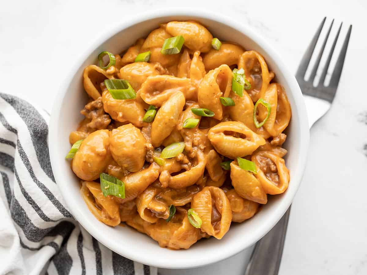 Overhead view of cheeseburger pasta in a bowl with a fork on the side