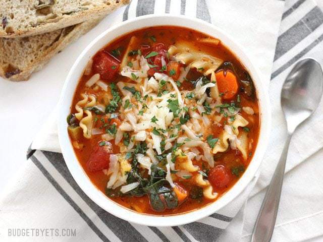 Finished bowl of Garden Vegetable Lasagna soup with bread on the side