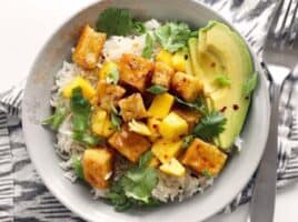 Mango Coconut Tofu Bowls with savory coconut rice and a tangy honey lime glaze. BudgetBytes.com