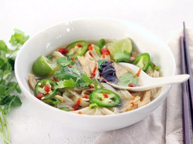 Front view of a bowl of Quickie Faux Phở with a spoon in the middle