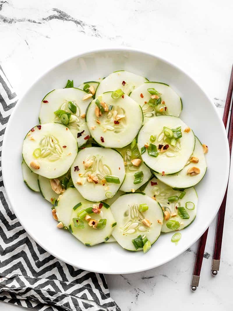 A bowl of Sesame Cucumber Salad from above, chopsticks on the side