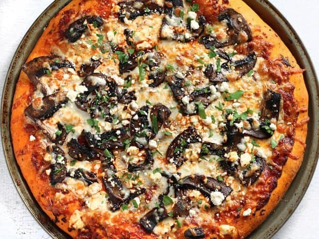 Baked Ultimate Portobello Mushroom Pizza not yet sliced, garnished with parsley