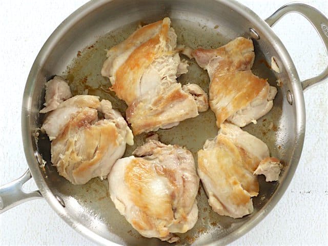 Browned Chicken Thighs in a deep skillet