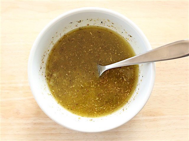 Finished Lemon Garlic Dressing and Marinade in a small white bowl