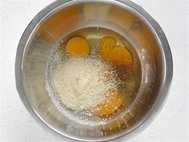 Eggs Parmesan Pepper in a bowl about to be whisked together