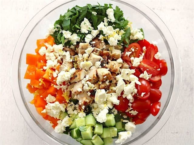 Pasta Vegetables Chicken Feta Lemon Zest in a bowl