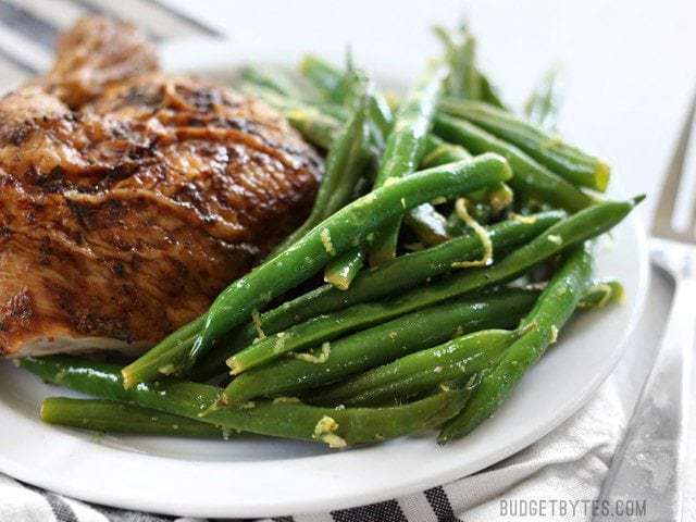 Lemon butter green beans served in a plate.