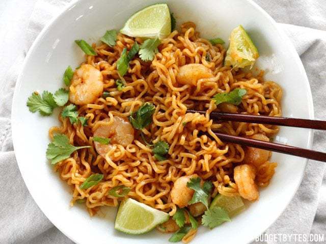 Lime shrimp dragon noodles coriander and lime with chopsticks.