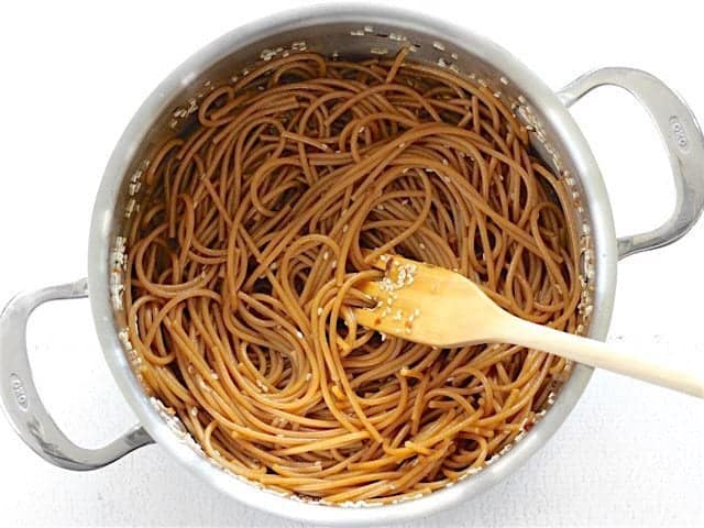 Sesame Noodles in the pot with a wooden pasta fork